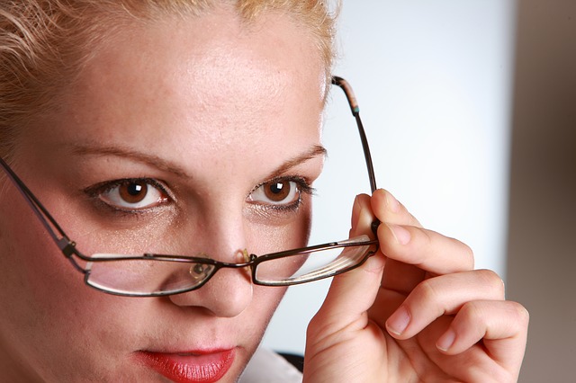 woman looking over glasses